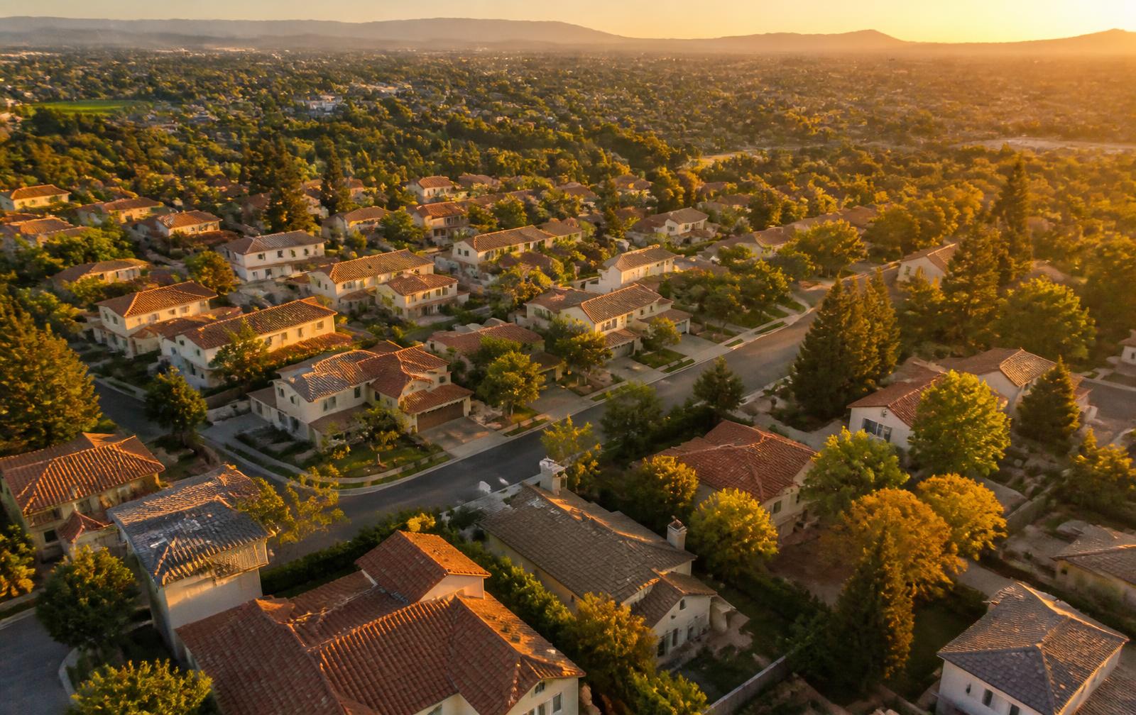 Aerial view of a suburban residential neighborhood at golden hour