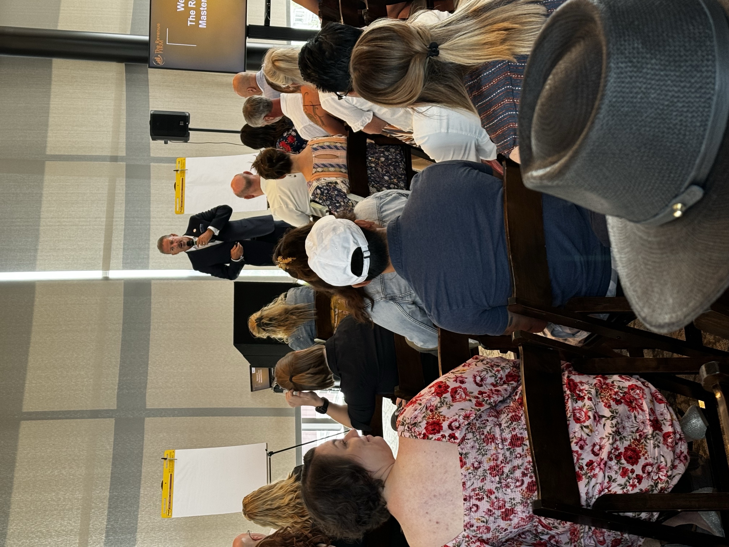 A packed room of title, mortgage, and real estate professionals at a Revenue Firm event